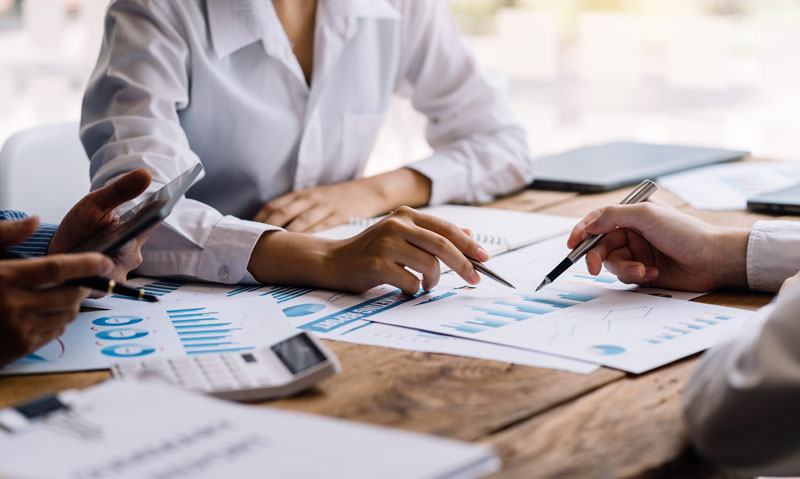 People going over a plan on paper on desk